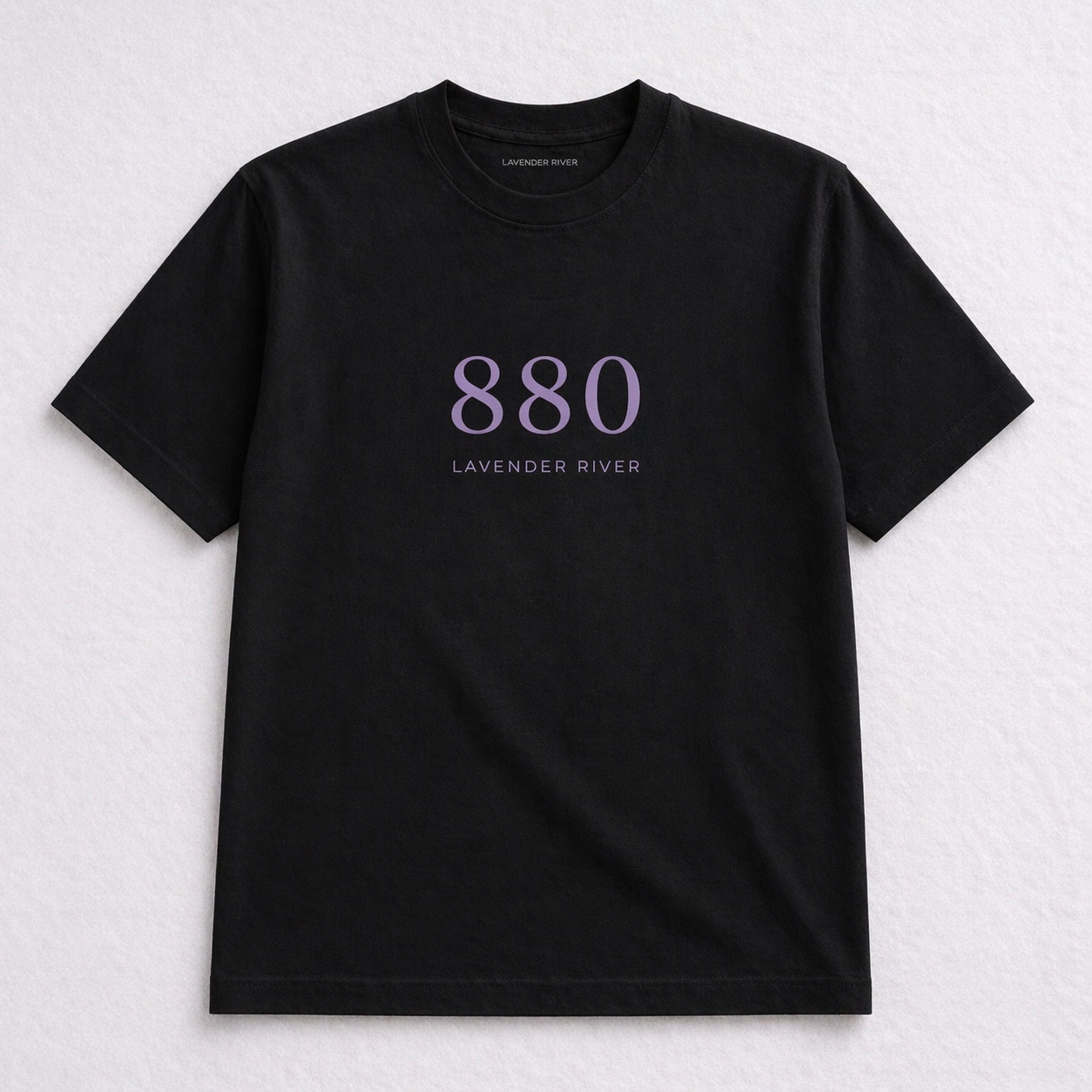 Black tee with large lavender 880 numerals and Lavender River wordmark, flat-lay detail