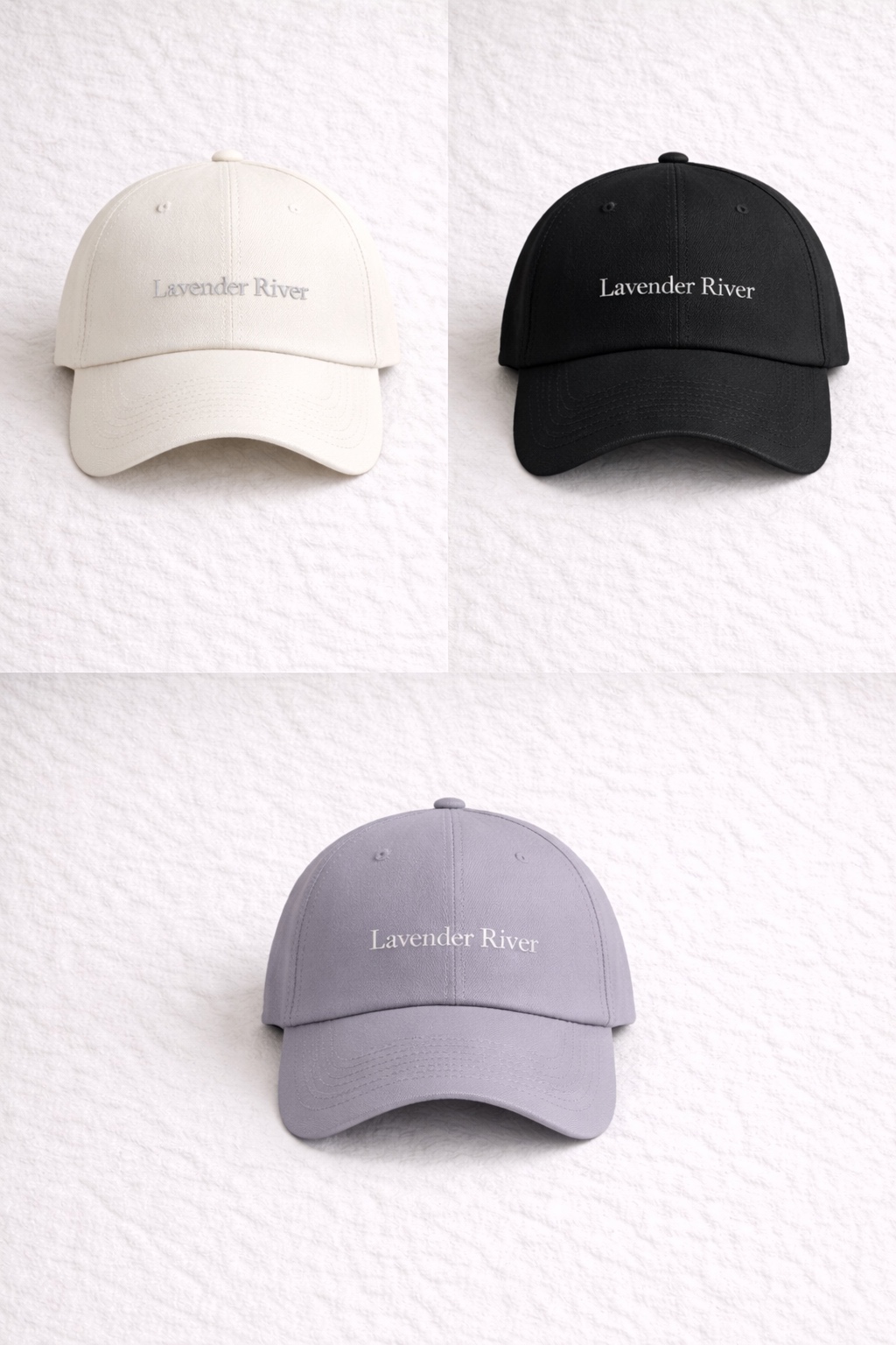 Lavender River caps in ivory, black, and lavender with embroidered wordmark